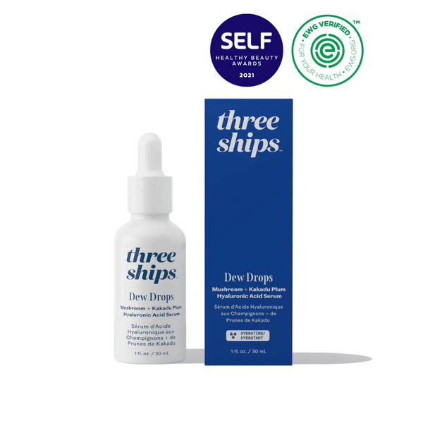 Three Ships Dew Drops Mushroom + Kakadu Plum Hyaluronic Acid Serum in white dropper bottle with matching navy blue box packaging, featuring skincare award and EWG verified logos.
