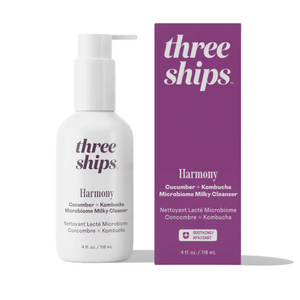 Bottle and purple box packaging of Harmony Cucumber + Kombucha Microbiome Milky Balancing Cleanser | Three Ships, a skincare product with soothing properties.