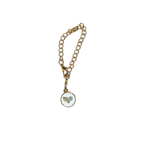 Gold chain tumbler charm with a small round pendant featuring a blue heart and wing design, part of the Tumbler Charm | Live Love Spa collection.