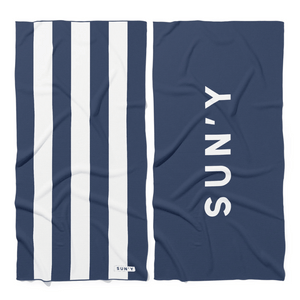Waffle Microfiber Beach Towel - Nautical Navy | SUN'Y featuring navy and white stripes on one side and bold white branding on navy background on the other side.