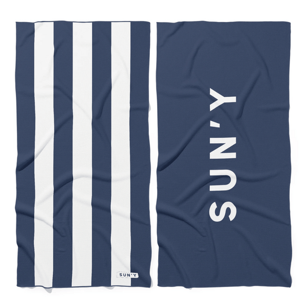 Waffle Microfiber Beach Towel - Nautical Navy | SUN'Y featuring navy and white stripes on one side and bold white branding on navy background on the other side.
