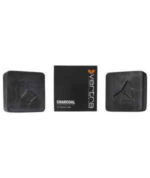 Charcoal Cleansing Bar x Brisa Hennessy | Vertra featuring two black charcoal soap bars with embossed logos and a black box with white and orange branding, ideal for skincare and body care.