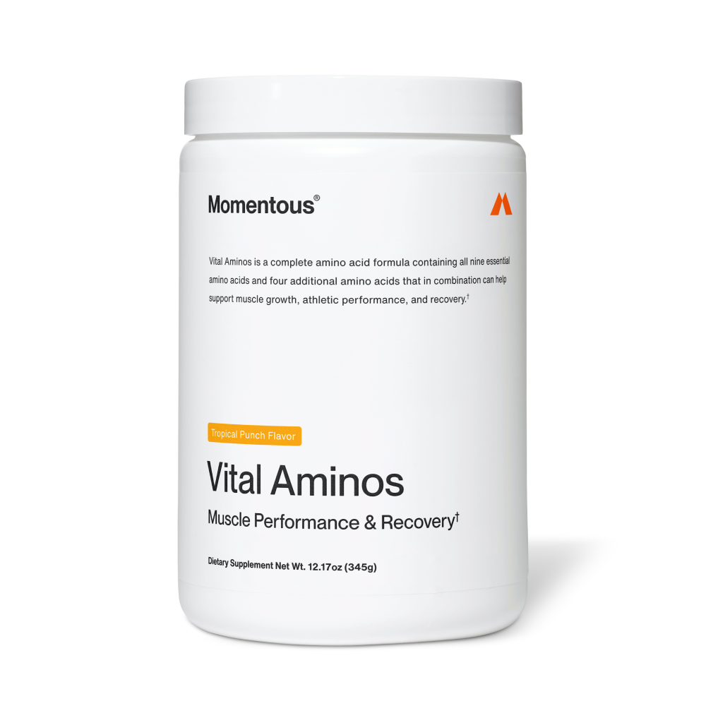 White container of Vital Aminos dietary supplement by Momentous with tropical punch flavor, designed to support muscle performance and recovery.
