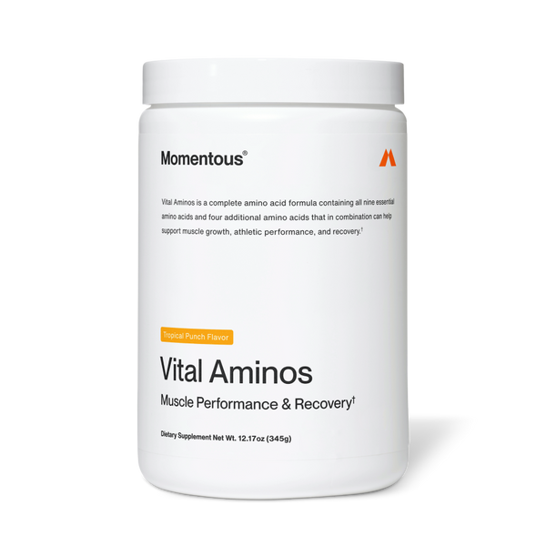 White container of Vital Aminos dietary supplement by Momentous with tropical punch flavor, designed to support muscle performance and recovery.