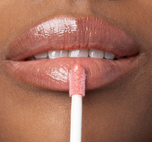Close-up of lips applying Vitamin Glaze® Oil Infused Lip Gloss – Peach Peony | Farmhouse Fresh, showing glossy, sheer peach-colored finish enhancing natural lip beauty.