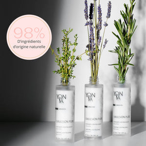 Three bottles of Emulsion Pure Purifying Tonic | Yon-Ka Paris displayed with sprigs of natural herbs, highlighting 98 percent natural origin ingredients for gentle skincare.