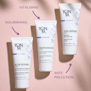 Nutri Defense Creme | Yon-Ka Paris skincare tube displayed with two other tubes on a soft pink background, highlighting nourishing, vitalising, and anti-pollution benefits.