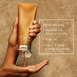 Hand holding a tube of Body Polishing Scrub | Moroccanoil dispensing brown exfoliating scrub with usage instructions for skincare and body care wellness.