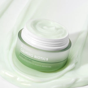 Open jar of Calming Biotics Blemish Cream | Leaders with smooth green-tinted cream on a matching pale green background, highlighting skincare for sensitive skin.