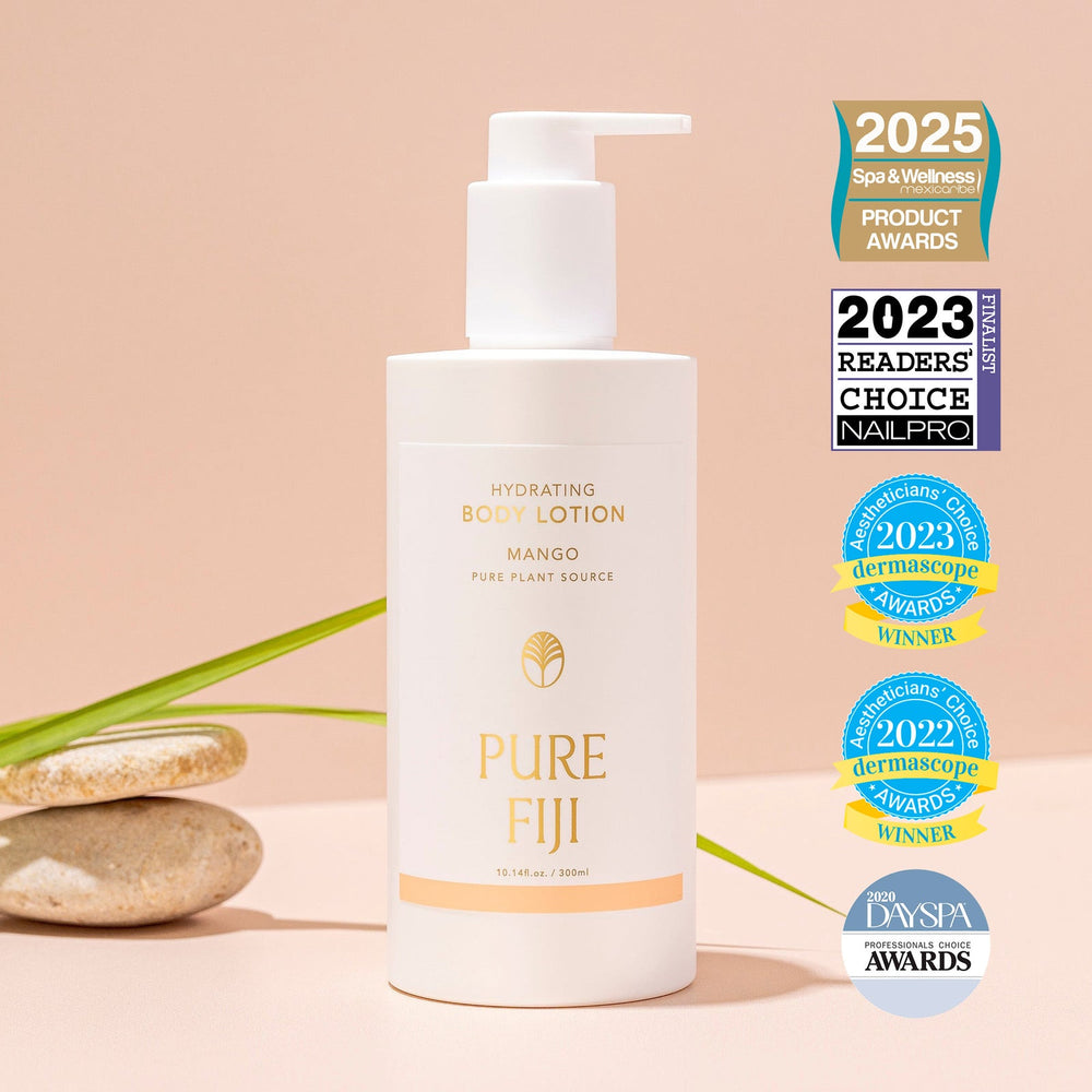 Hydrating Body Lotion | Pure Fiji bottle with pump dispenser displayed alongside spa stones and green leaves, featuring multiple wellness and skincare award badges.