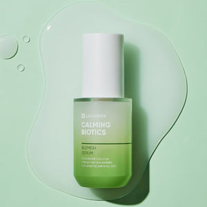 Calming Biotics Blemish Serum | Leaders in a green gradient bottle with white cap on a light green background with clear serum drops, highlighting skincare for sensitive skin.