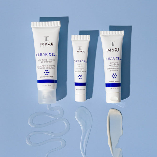 CLEAR SKIN SOLUTIONS Blemish Defense Trio | IMAGE Skincare featuring three white skincare tubes on a blue background with corresponding product textures displayed below each tube.