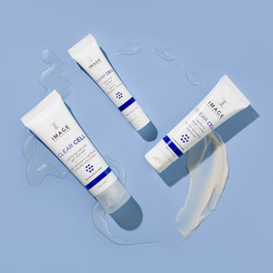 CLEAR SKIN SOLUTIONS Blemish Defense Trio | IMAGE Skincare with three white and blue skincare tubes on a blue background, surrounded by clear and creamy product textures for skincare and wellness.
