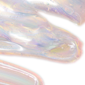 Close-up of iridescent skincare gel texture showcasing smooth, translucent layers with subtle pink and purple hues, representing Crystal Dew Drops For Eyes & Lips | Skin Fitness Therapy.