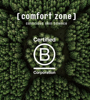 Aerial view of dense green forest with the text "[ comfort zone ] conscious skin science Certified B Corporation" overlayed, representing the brand's commitment to sustainable skincare and wellness with Luminant Cream | [ comfort zone ].