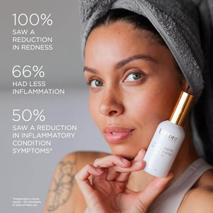 Woman with a towel wrapped around her head holding a bottle of Discovery Kit | LaFlore, promoting skincare benefits such as reduced redness and inflammation.