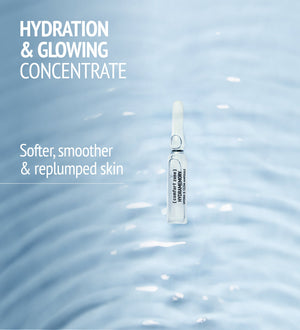Single clear ampoule floating on soft rippling water surface with text highlighting hydration and glowing concentrate for softer, smoother, and replumped skin by Hydramemory Hydra & Glow Ampoules | [ comfort zone ].