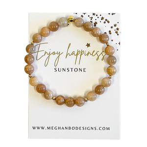 Joy Intention Bracelet | Meghan Bo featuring round sunstone beads with small gold accents on a card reading "Enjoy happiness" in elegant script.