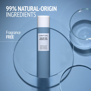 Bottle of Sublime Skin Micropeel Lotion | [ comfort zone ] on a blue surface with text highlighting 99% natural-origin ingredients and fragrance-free skincare product.
