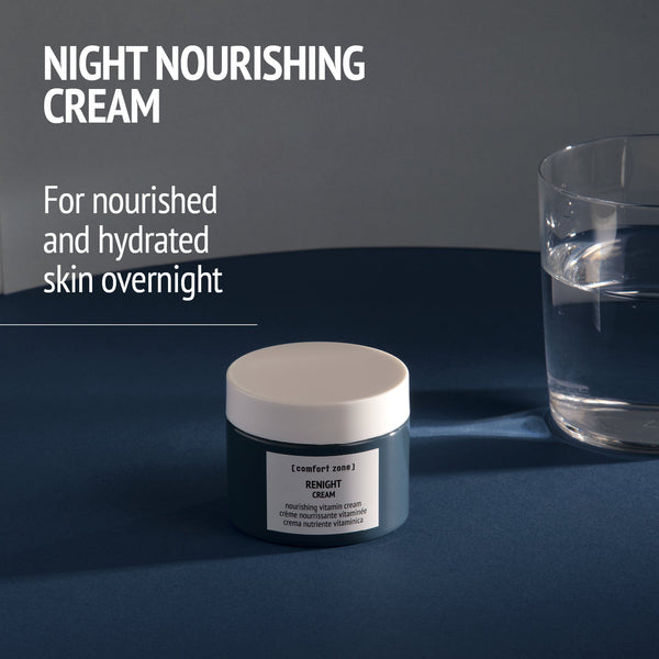 Jar of Kit Night Garden | [ comfort zone ] nourishing night cream on a dark surface next to a glass of water with soft lighting, promoting hydration and skin nourishment overnight