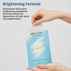Person holding a blue packet of Leaders Skin Clinic Mask Mela-Tox | Leaders with a white mask being pulled out, highlighting its brightening formula for reducing dark spots and pigmentation.