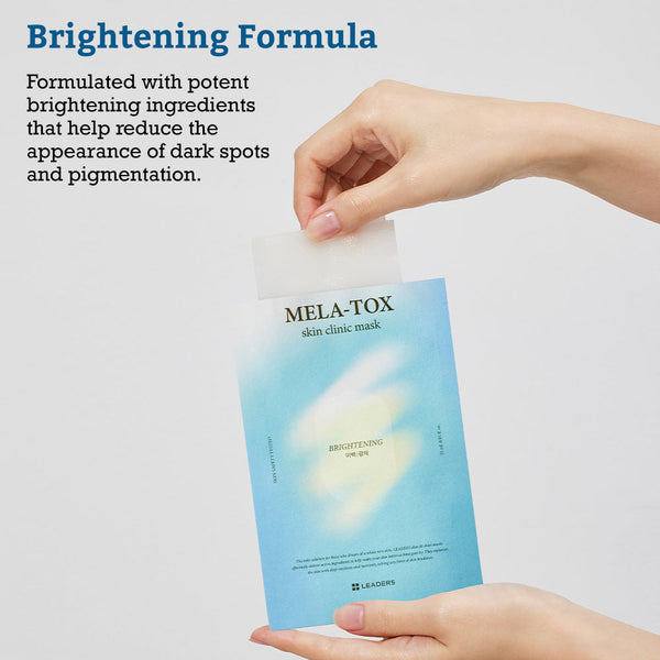 Person holding a blue packet of Leaders Skin Clinic Mask Mela-Tox | Leaders with a white mask being pulled out, highlighting its brightening formula for reducing dark spots and pigmentation.