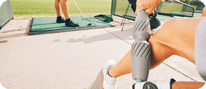 A person using the RAD Muscle Flushing Kit | RAD recovery tool on their calf outdoors, demonstrating its use in muscle care and wellness.