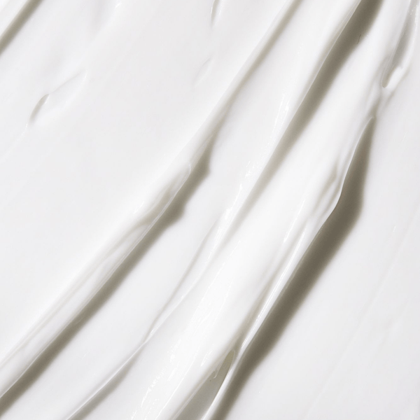 Close-up texture of a smooth, creamy white lotion illustrating the rich formula of Body Cream | NUDA for luxurious skincare and body care hydration.