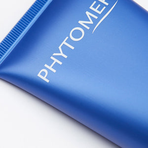 Close-up of a blue tube of Olécrème Hand Cream | Phytomer featuring the brand name printed in white on a smooth surface, highlighting skincare product packaging.