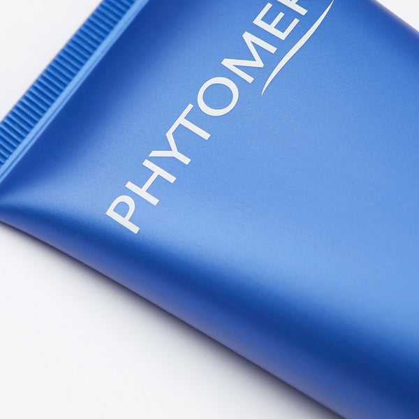 Close-up of a blue tube of Olécrème Hand Cream | Phytomer featuring the brand name printed in white on a smooth surface, highlighting skincare product packaging.