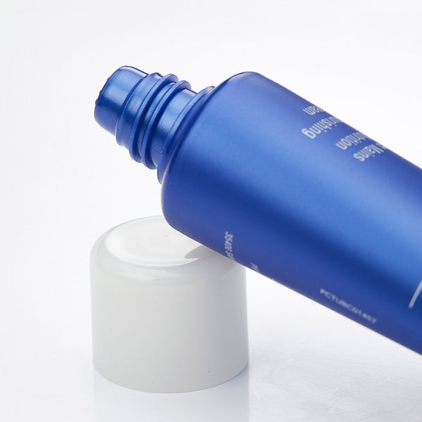 Close-up of an open blue tube of Olécrème Hand Cream | Phytomer with a white cap on a white surface, highlighting skincare product packaging.