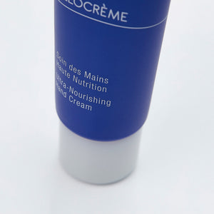 Close-up of a blue and white tube of Olécrème Hand Cream | Phytomer, labeled as ultra-nourishing skincare for hands, against a white background.