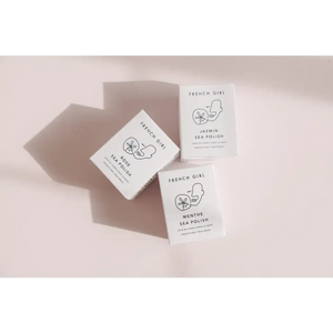 Three minimalist French Girl skincare product boxes in soft natural light, featuring Rose Body Polish | French Girl along with Jasmin and Menthe Sea Polish varieties.