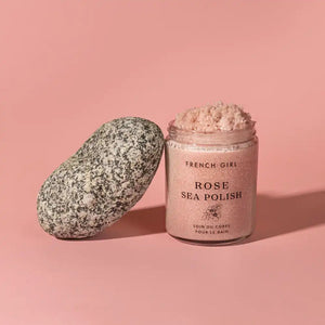 Jar of Rose Body Polish | French Girl with pink exfoliating scrub next to a smooth speckled stone on a soft pink background, showcasing natural skincare and body care.