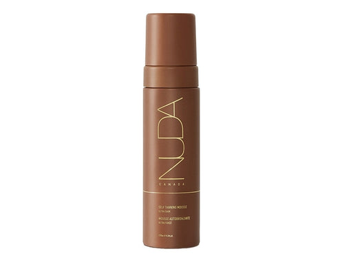 Brown cylindrical bottle with gold lettering containing Self Tanning Mousse | NUDA, a skincare product for a natural tan.