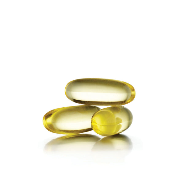 Three translucent yellow softgel capsules representing Skin Omegas Supplement | Jane Iredale for skincare and wellness supplements.
