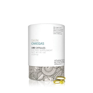Minimalist white container of Skin Omegas Supplement | Jane Iredale with botanical pattern near base and three golden capsules displayed in front on white background