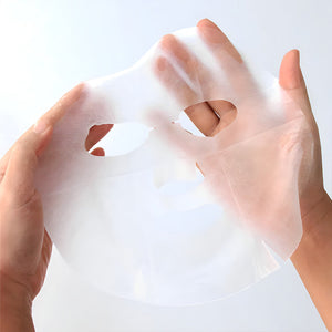 Hands holding a translucent sheet mask designed for facial skincare, for use with the Tea Tree Relaxing Skin Renewal Mask | Leaders, promoting skin renewal and relaxation.