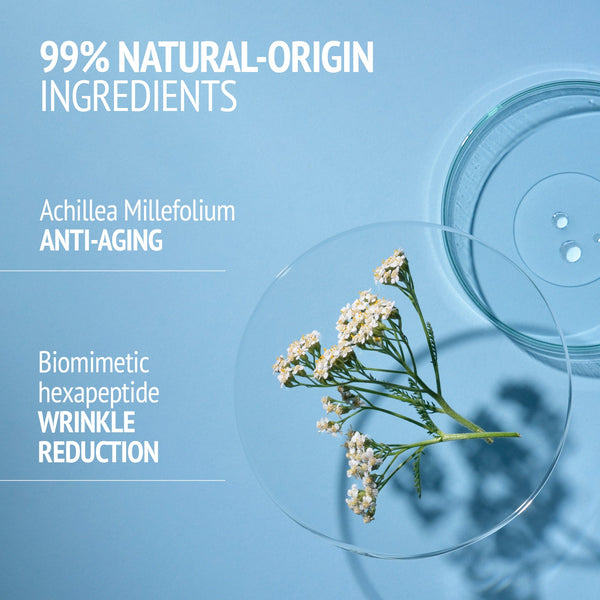 Close-up of a small white flowering plant on a blue surface with text highlighting natural-origin ingredients and anti-aging benefits, related to Kit Italian Garden | [ comfort zone ].