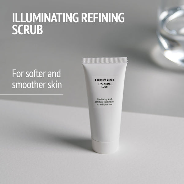 Tube of Essential Scrub | [ comfort zone ] displayed on a light surface with text highlighting its illuminating refining scrub benefits for softer and smoother skin in skincare and body care.