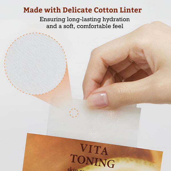 Close-up of a hand holding a delicate cotton liner sheet from the Leaders Skin Renewal Mask Vita Toning | Leaders package, highlighting the soft and hydrated texture for skincare use.