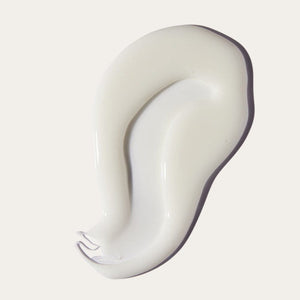 Creamy white wax smear on a light background representing the texture of I'm Sensitive Meltdown Vegan Hard Wax | Crybaby Wax for skincare and body care.
