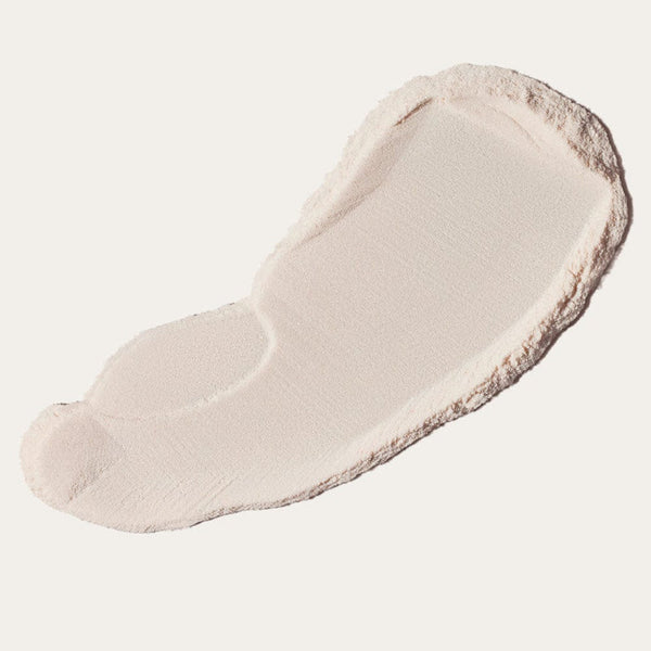 Smooth light beige powder texture spread on a pale surface representing A Wail of a Time Priming Powder | Crybaby Wax for skincare and body care use.