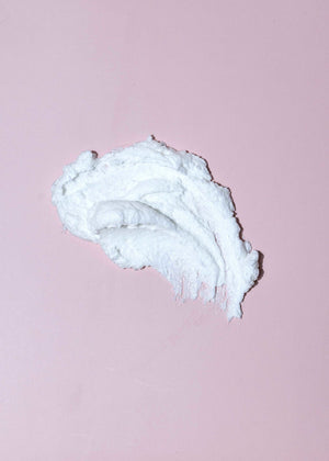 Whip Scrub | Latika cream texture on a soft pink background, showcasing a rich, airy consistency ideal for skincare and body care routines.