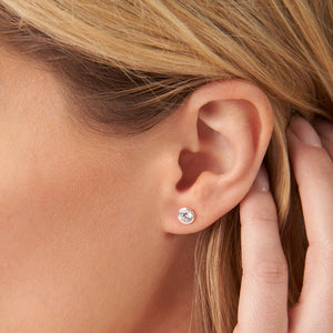 Close-up of a woman wearing simple round stud earrings with a clear gemstone, showcasing the Jelly Tots Earrings | LIttle Sparkles style.