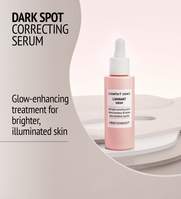 Bottle of Luminant Serum | [ comfort zone ] in soft pink packaging with dropper, displayed as a dark spot correcting skincare product for brighter, illuminated skin.