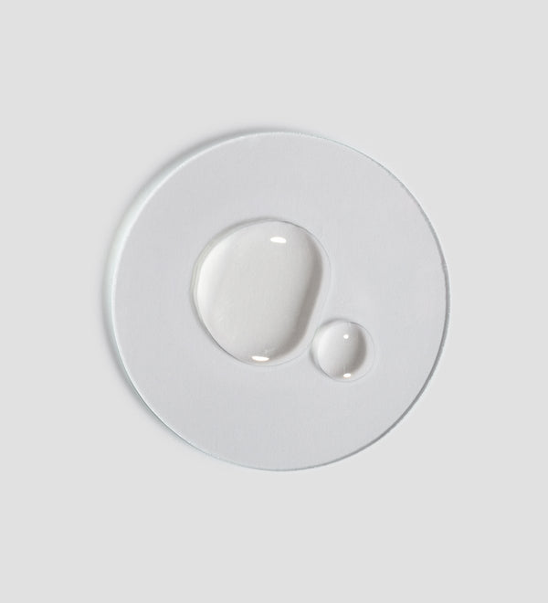 Clear droplets of Renight Oil | [ comfort zone ] skincare product displayed on a white surface highlighting its lightweight, nourishing texture ideal for body care and wellness.