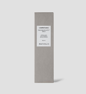 Minimalist gray rectangular box packaging for Tranquillity Spray | [ comfort zone ] with a white label featuring simple black text on a plain light gray background.