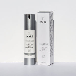Bottle and box packaging of AGELESS total anti-aging serum | IMAGE Skincare displayed on a plain white background, highlighting the sleek silver and white design for skincare use.