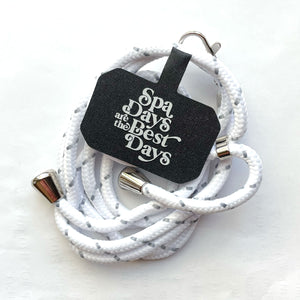 Crossbody Phone Lanyard With Adjustable Strap | Live Love Spa in white with silver accents, featuring a black tag that says "Spa Days are the Best Days.